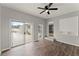 This bedroom has hard surface floors and glass doors overlooking the backyard at 1027 Bel Aire Dr, Daytona Beach, FL 32118