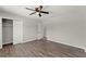 Bedroom with gray wood floors, neutral walls, a ceiling fan, and closet at 1027 Bel Aire Dr, Daytona Beach, FL 32118
