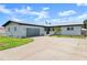 Welcoming home exterior with a garage, well-manicured lawn, a decorative fence, and an inviting front porch at 1027 Bel Aire Dr, Daytona Beach, FL 32118