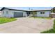 Charming single-story home featuring a spacious driveway and well-maintained front yard with a beautiful tree at 1027 Bel Aire Dr, Daytona Beach, FL 32118
