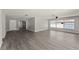 An open living area with plenty of natural light and featuring durable, wood-look flooring throughout the space at 1027 Bel Aire Dr, Daytona Beach, FL 32118