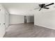 A bright and spacious living area features durable, wood-look flooring and a ceiling fan for added comfort at 1027 Bel Aire Dr, Daytona Beach, FL 32118