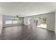 Open living room with gray wood floors, neutral walls, and bright, natural light at 1027 Bel Aire Dr, Daytona Beach, FL 32118