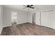 This main bedroom features wood-look floors and an adjacent bathroom and closet at 1027 Bel Aire Dr, Daytona Beach, FL 32118