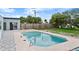 Inviting pool area with a wooden fence, lush greenery, and convenient access to the home's sliding glass door at 1027 Bel Aire Dr, Daytona Beach, FL 32118