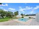 Backyard view of the in-ground pool and patio area, complemented by lush landscaping at 1027 Bel Aire Dr, Daytona Beach, FL 32118