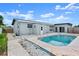 Relaxing in-ground pool area with patterned patio, white stone accents, and access to the home's exterior at 1027 Bel Aire Dr, Daytona Beach, FL 32118