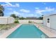 Inviting in-ground pool in a private backyard with white fence and storage shed, perfect for outdoor relaxation at 1027 Bel Aire Dr, Daytona Beach, FL 32118