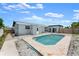 Rear view of the home's in-ground pool with tile surround, complemented by easy access to the house at 1027 Bel Aire Dr, Daytona Beach, FL 32118