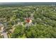 Aerial view of a home nestled amongst lush trees, showing its location in a verdant, green neighborhood at 1205 Weeping Willow Dr, Deland, FL 32724
