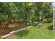 Well-maintained backyard showcasing mature trees and a small seating area at 1205 Weeping Willow Dr, Deland, FL 32724