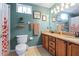 Inviting bathroom with double vanity, framed mirrors, and a shower/tub combination with a decorative shower curtain at 1205 Weeping Willow Dr, Deland, FL 32724