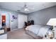 Bright bedroom featuring neutral walls, a ceiling fan, a closet, and a comfortable bed next to the adjacent room at 1205 Weeping Willow Dr, Deland, FL 32724