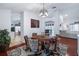 Dining room featuring a decorative rug and chandelier with view of Kitchen, Living Room and Pool at 1205 Weeping Willow Dr, Deland, FL 32724