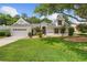 Charming single-Gathering home featuring lush lawn, mature trees, and well-maintained landscaping at 1205 Weeping Willow Dr, Deland, FL 32724