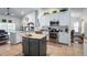 Bright kitchen with stainless steel appliances, an island, and lots of cabinet space at 1205 Weeping Willow Dr, Deland, FL 32724