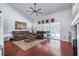 Cozy living room with hardwood floors, ceiling fan, a built-in bookcase, and a pool view at 1205 Weeping Willow Dr, Deland, FL 32724