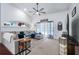 Comfortable living room featuring vaulted ceilings, ceiling fan, and sliding glass doors to the pool at 1205 Weeping Willow Dr, Deland, FL 32724