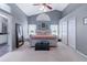 Bright main bedroom featuring a ceiling fan, large windows, and walk in closet at 1205 Weeping Willow Dr, Deland, FL 32724