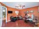 Office with orange walls, comfortable seating, a desk with computer, and access to an adjacent bathroom, creating a functional workspace at 1205 Weeping Willow Dr, Deland, FL 32724