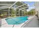 Relaxing screened-in pool area, featuring a sparkling pool, lush greenery, and a serene outdoor space for enjoyment at 1205 Weeping Willow Dr, Deland, FL 32724