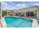Sparkling screened-in pool with an inviting outdoor area, featuring comfortable seating and lush landscaping for relaxation at 1205 Weeping Willow Dr, Deland, FL 32724