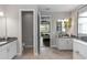 Modern bathroom with white cabinets, granite countertop, and view into Primary bedroom at 1227 Victoria Hills N Dr, Deland, FL 32724