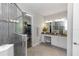 Spacious bathroom boasts glass shower, vanity with granite counters, and walk-in closet at 1227 Victoria Hills N Dr, Deland, FL 32724