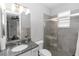Modern bathroom featuring a glass-enclosed shower, granite countertops, and neutral color palette at 1227 Victoria Hills N Dr, Deland, FL 32724