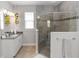 Bathroom showcasing glass shower, granite counter, and stylish gray tile at 1227 Victoria Hills N Dr, Deland, FL 32724