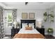 Bright bedroom with large window, plants, neutral decor, and a comfortable bed at 1227 Victoria Hills N Dr, Deland, FL 32724