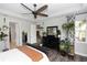 Bedroom with a black dresser, hard wood floors, and hanging potted plants at 1227 Victoria Hills N Dr, Deland, FL 32724
