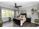 Bedroom featuring a dark wood bed, ceiling fan, and hanging potted plants at 1227 Victoria Hills N Dr, Deland, FL 32724