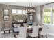 Dining room with a modern light fixture, seating for six, and natural light at 1227 Victoria Hills N Dr, Deland, FL 32724