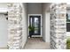 Close-up of the home's front door with stone pillars and decorative plants at 1227 Victoria Hills N Dr, Deland, FL 32724