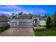 Charming single-story home with a brick driveway, three-car garage, and landscaped yard at 1227 Victoria Hills N Dr, Deland, FL 32724