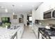 Spacious kitchen with an island, granite countertops, and open view to the adjacent living spaces at 1227 Victoria Hills N Dr, Deland, FL 32724