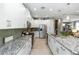 Bright kitchen with white cabinets, granite countertops, stainless steel appliances, and tile flooring at 1227 Victoria Hills N Dr, Deland, FL 32724