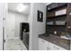 Functional laundry room with sleek appliances, granite counters, and modern decor at 1227 Victoria Hills N Dr, Deland, FL 32724