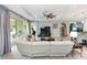 Open concept living room with tile floors, ceiling fan, and large sectional sofa at 1227 Victoria Hills N Dr, Deland, FL 32724