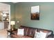 Living room featuring a leather couch, side table with a lamp, and olive green walls at 1227 Victoria Hills N Dr, Deland, FL 32724