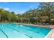 Inviting pool area with lounge chairs, covered seating, and clear blue water for relaxing and swimming at 1227 Victoria Hills N Dr, Deland, FL 32724