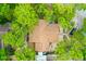 Top-down aerial view of the home shows the roof and surrounding landscape, with trees and a driveway at 127 Cypress Pond Rd, Port Orange, FL 32128