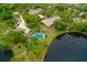 Aerial view featuring a home with a pool and lake view at 127 Cypress Pond Rd, Port Orange, FL 32128