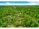Aerial shot of a home nestled in a tree-filled neighborhood, creating a tranquil atmosphere with a canopy of greenery at 127 Cypress Pond Rd, Port Orange, FL 32128