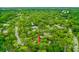 Wide aerial view showcases a home immersed in a verdant, tree-covered landscape, enhancing its natural charm and privacy at 127 Cypress Pond Rd, Port Orange, FL 32128