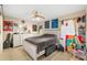 Bedroom with tile floor, ceiling fan and a bed with guitar and art decor at 127 Cypress Pond Rd, Port Orange, FL 32128