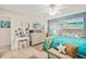 Spacious bedroom with coastal decor, featuring a vanity, dresser, and an ocean-themed color scheme to create a relaxing retreat at 127 Cypress Pond Rd, Port Orange, FL 32128