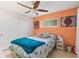 Bright bedroom with a modern ceiling fan, window, and comfortable furnishings, creating a cozy and inviting space at 127 Cypress Pond Rd, Port Orange, FL 32128