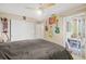 Bedroom featuring a ceiling fan, closet and slider to the sunroom at 127 Cypress Pond Rd, Port Orange, FL 32128